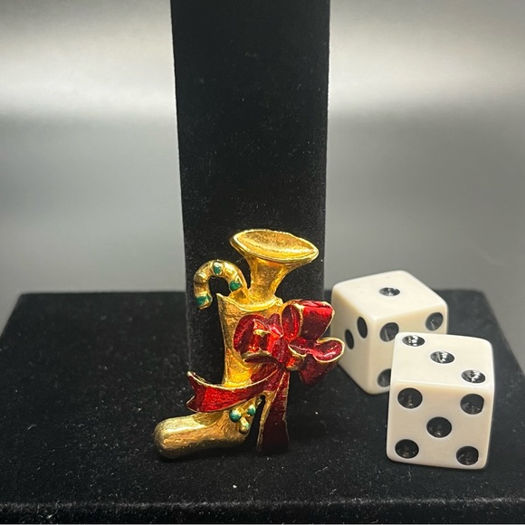 Christmas-themed brooch featuring a stocking, a candy cane, and a horn. - Picture 5 of 5